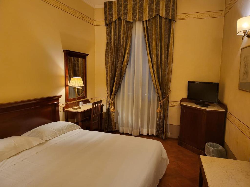Postel nebo postele na pokoji v ubytování Hotel Logge Dei Mercanti