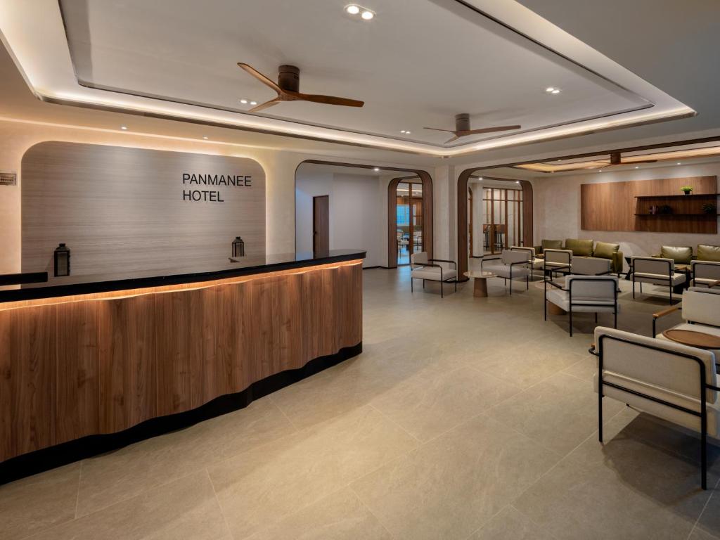 a lobby with a waiting area with chairs and aurance hotel sign at Panmanee Hotel in Phi Phi Don