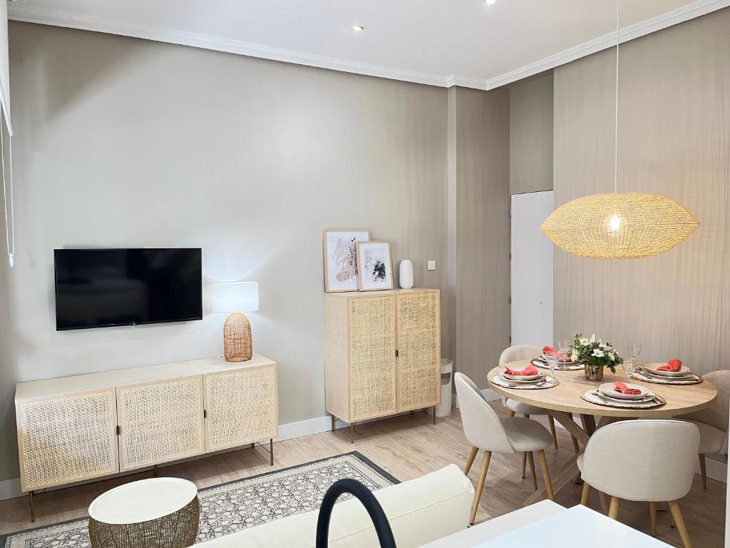 a living room with a table and a tv at COQUETO APARTAMENTO in Torrelavega