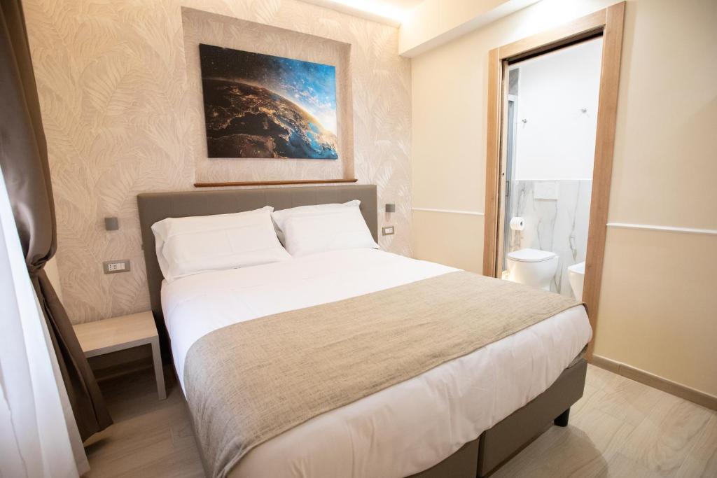 Postel nebo postele na pokoji v ubytování Hotel Maximus