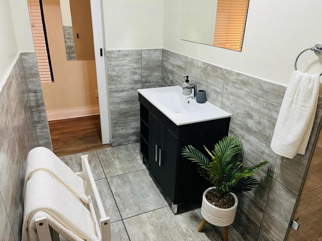 a bathroom with a sink and a potted plant at Eden on the bay Studio 67B in Bloubergstrand