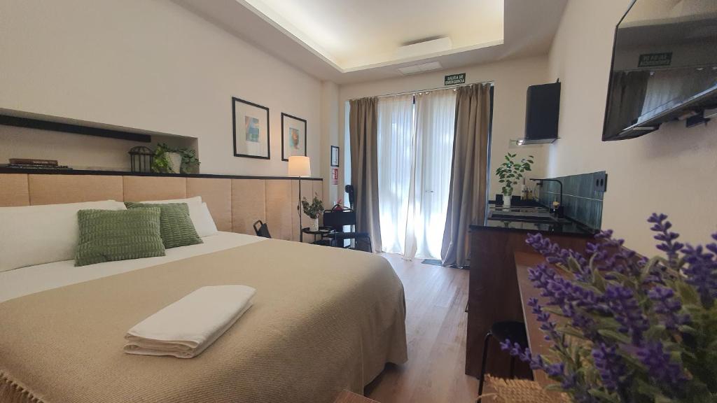 a bedroom with a bed with a towel on it at RentAdore Retiro Studio in Madrid