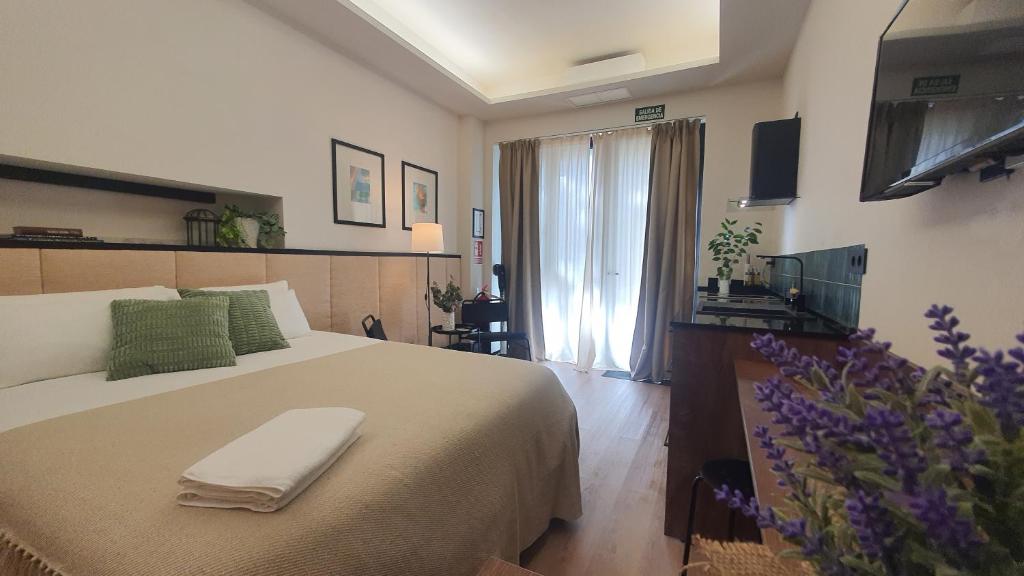 a bedroom with a bed with a towel on it at Retiro Studio in Madrid