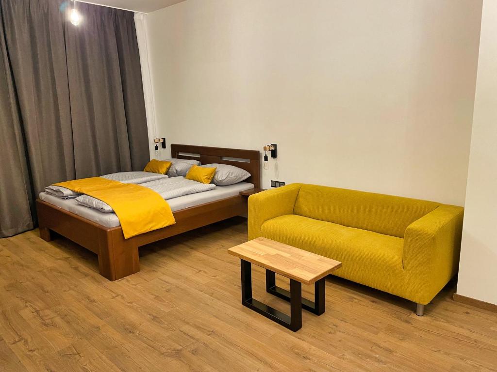 a bedroom with a bed and a couch at Apartment Elinel in Žilina