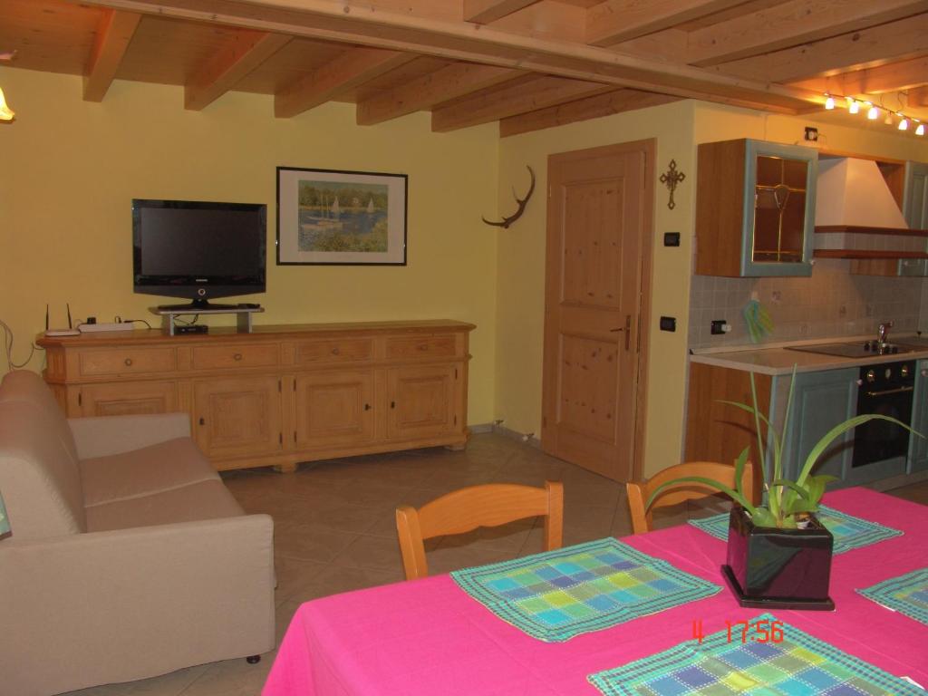 a living room with a table and a tv at Casa Martina in Livigno