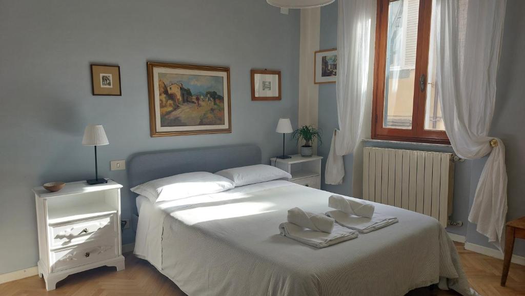 a bedroom with a white bed with towels on it at Residenza San Giorgio in Lucca