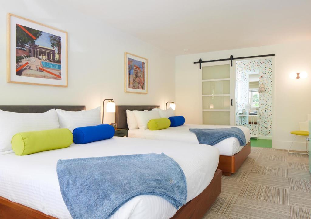 a bedroom with two beds and a window at Little Mod Hotel at the University in Charlottesville