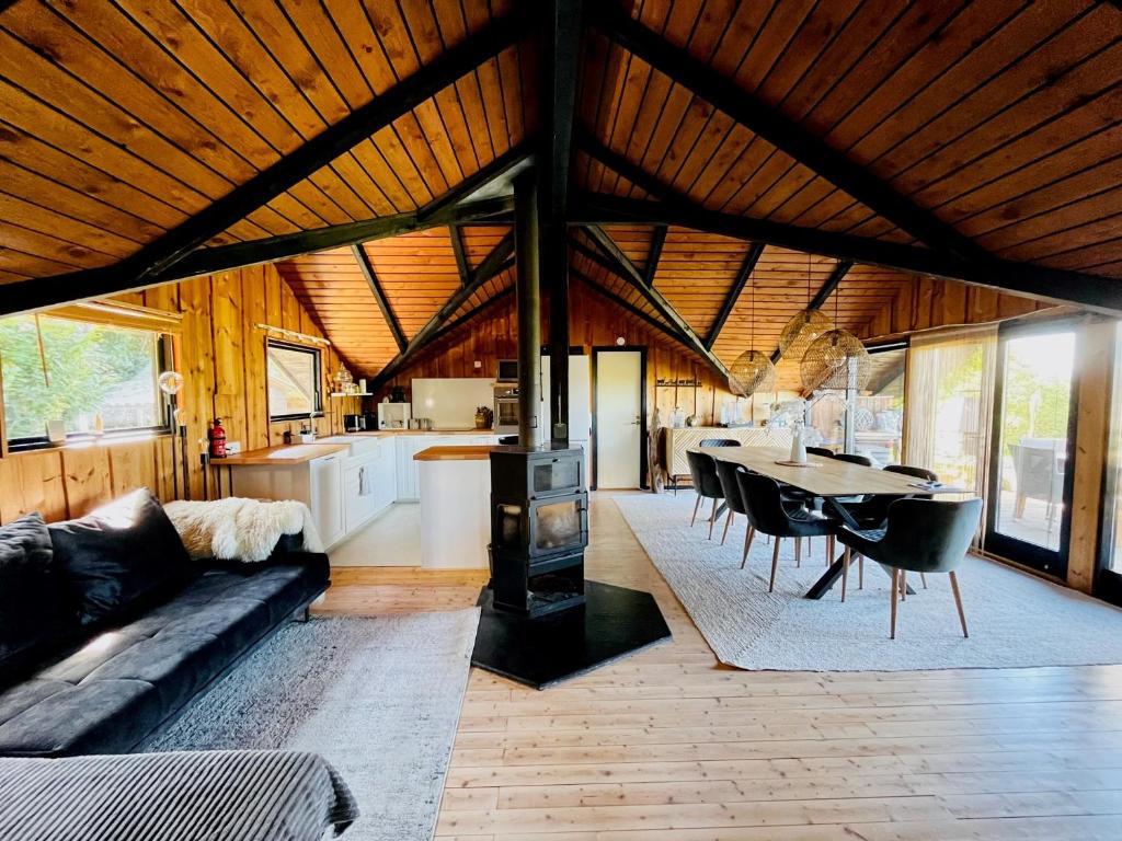 a living room with a couch and a table and a kitchen at Chalet - Kleines Paradies - in Appenzell