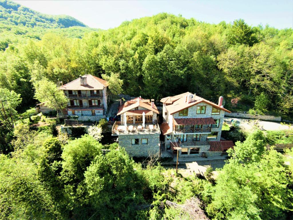 an aerial view of a house in a forest at Lydia Lithos Mountain Resort in Metamorfosi