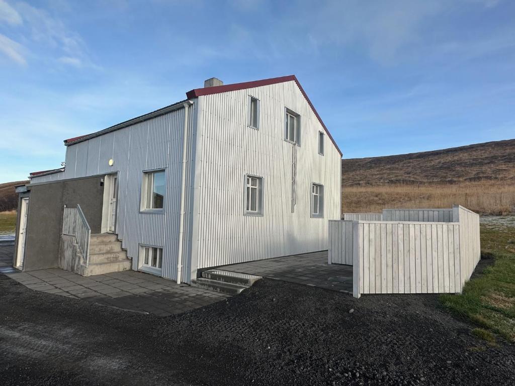 ein großes weißes Gebäude mit einer Rampe davor in der Unterkunft Original North in Þingeyjarsveit