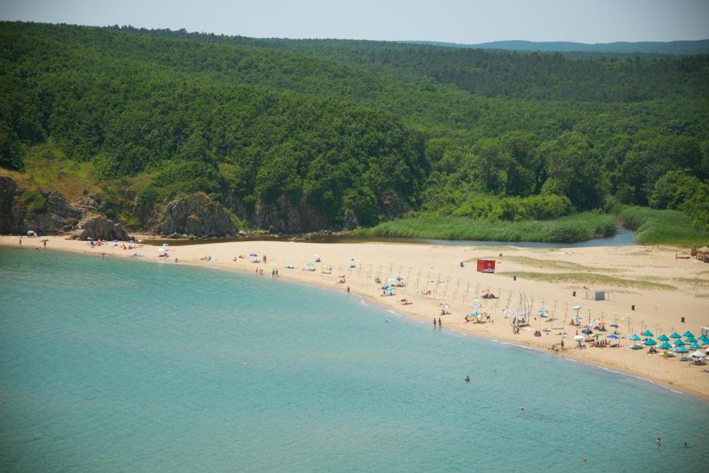 a group of people on a beach near the water at Apart Hotel Apolonia Palace in Sinemorets