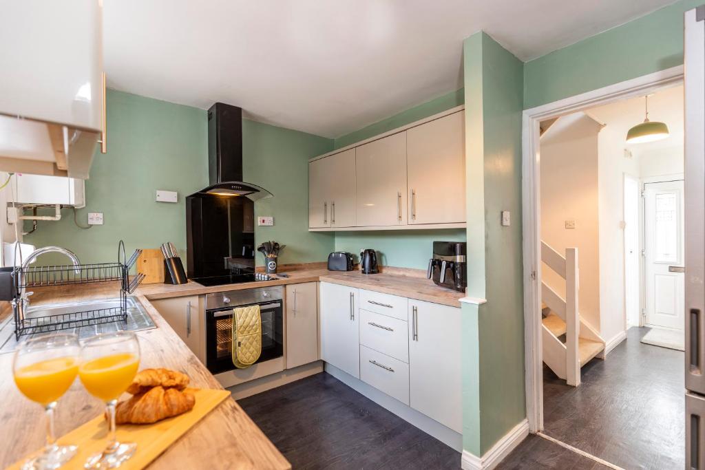 a kitchen with a table with two glasses of orange juice at Cherry House in Durham