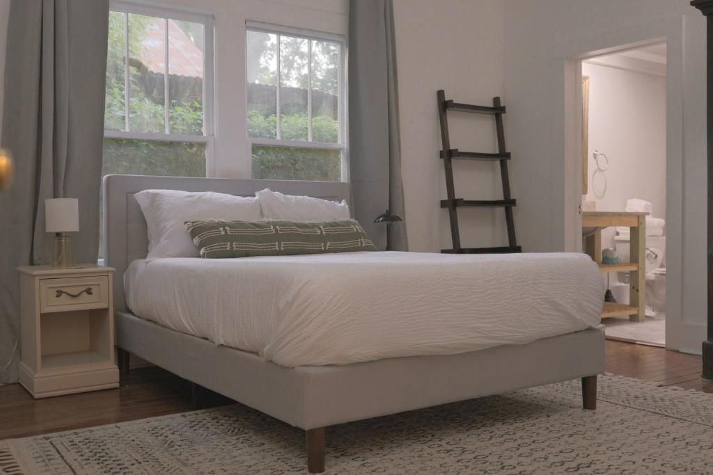 a bedroom with a large bed and a window at Clinton House - Master in Lafayette