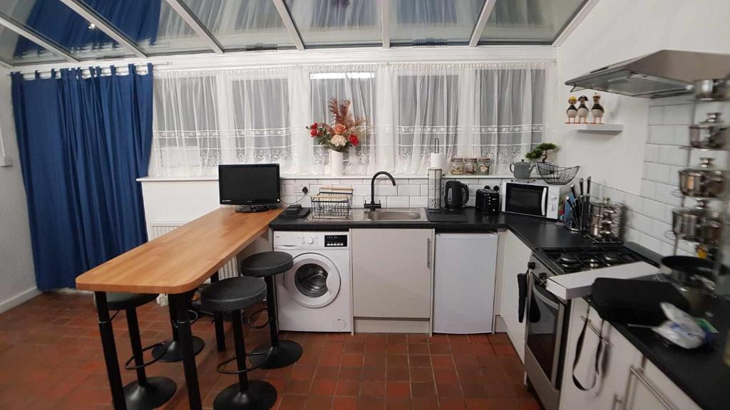 a kitchen with a counter and a sink and a stove at Puffin Place,Lloyd House in Haverfordwest