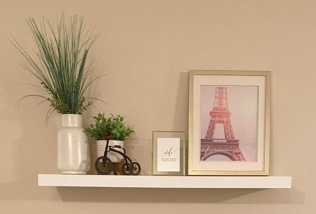 a shelf with two pictures and a picture of the eiffel tower at Cozy Condo at the Lake in Sylvan Lake