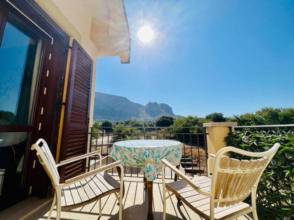 a patio with a table and chairs on a balcony at Esmaraldas House of Love in Terrasini