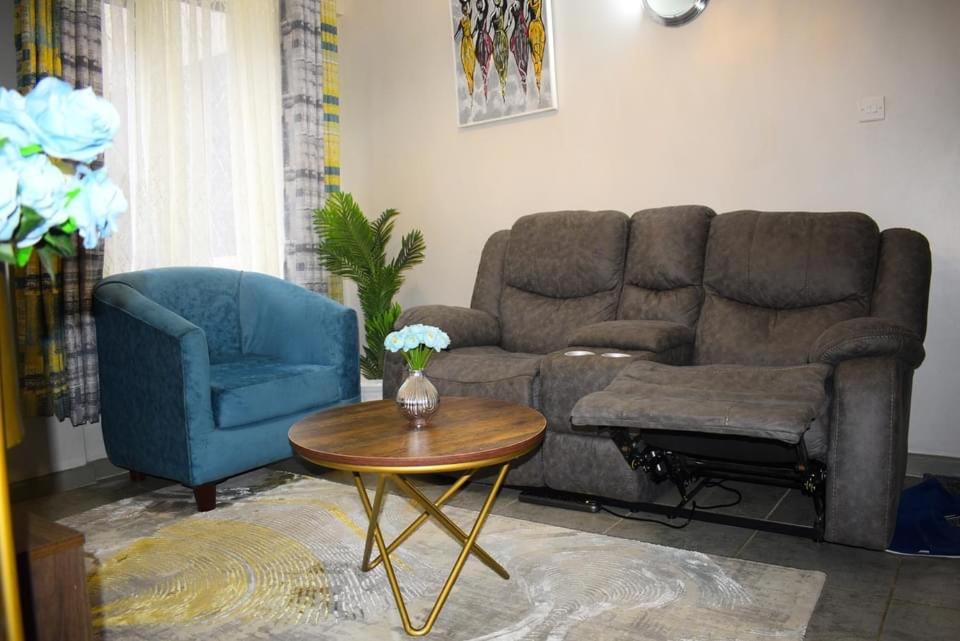 a living room with a couch and a table at A tastefully furnished one bedroom airbnb apartment along Thika rd, TRM mall in Nairobi