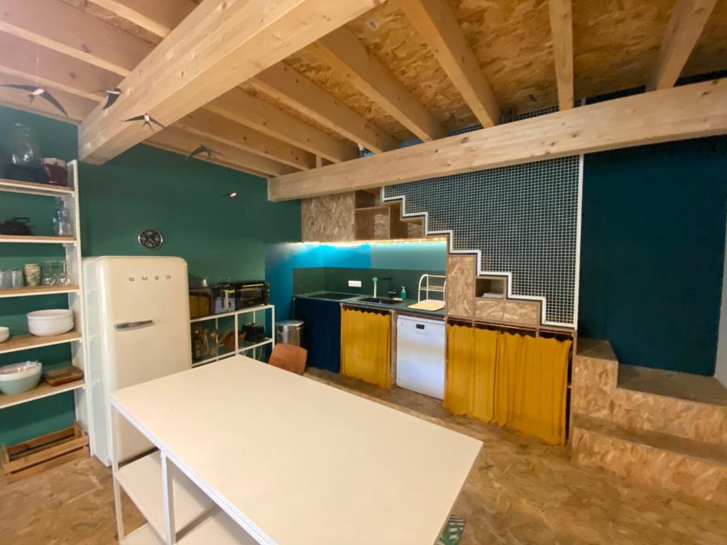 a kitchen with a white table in a room at Loft Saint-Jean in Monségur