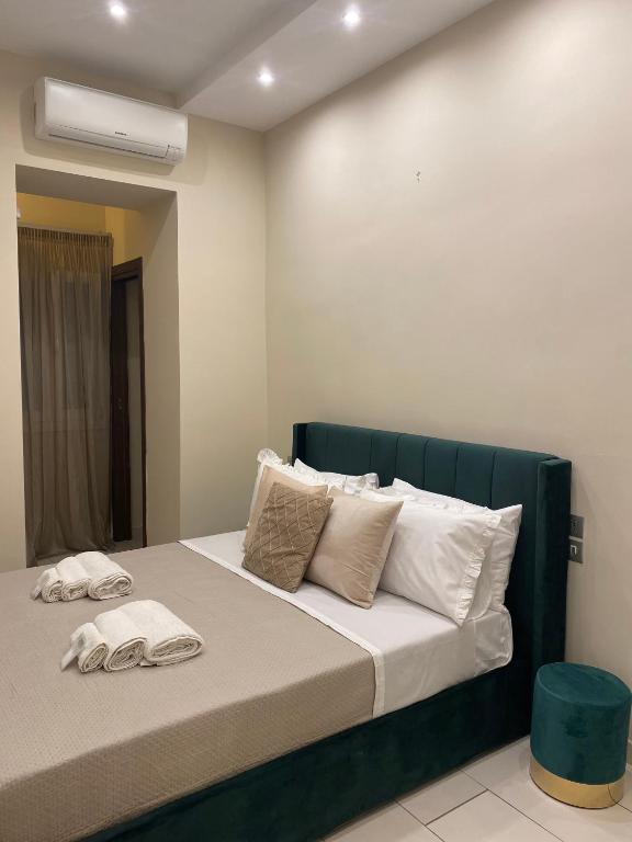 a bedroom with a bed with two towels on it at La Dimora di Antonella in Naples