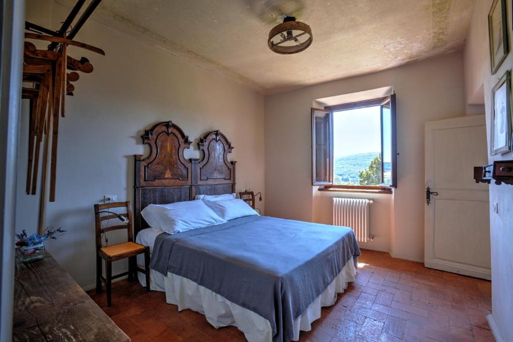 Postel nebo postele na pokoji v ubytování Palazzo Gatteschi