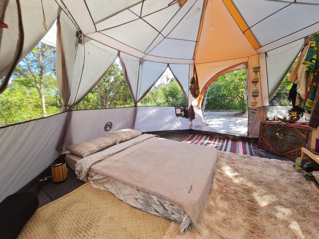 a bedroom with a bed in a tent at Que Brota Do Chão in Itacaré