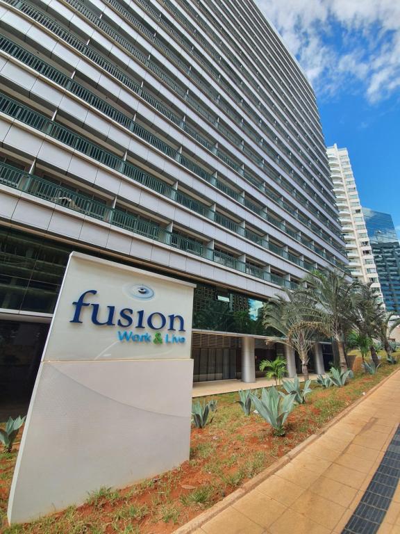 um sinal em frente a um edifício alto em Fusion Express By Rei dos Flats em Brasília