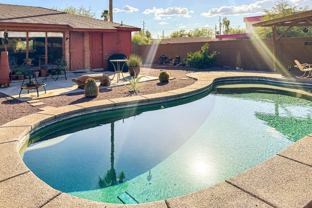 a swimming pool in a yard with a house at Hummingbird Hideaway in Tucson
