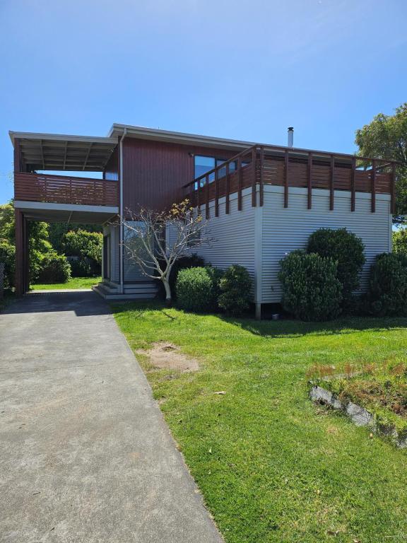 a building with a walkway in front of a yard at SeymourViews Apollo Bay in Apollo Bay