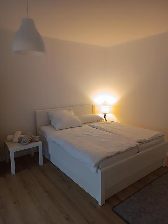 a bedroom with a bed with a lamp on it at Ksenia in Neumünster