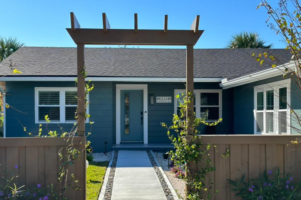 a blue house with a pergola at Palmetto Paradise - A in Saint Augustine
