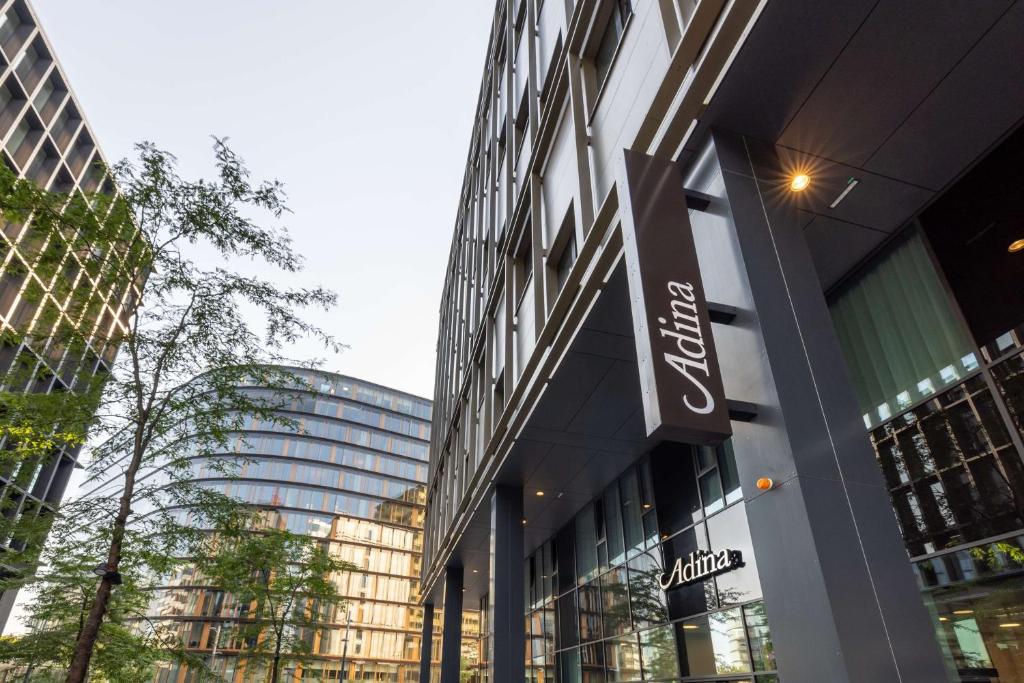 a building with a sign on the side of it at Adina Serviced Apartments Vienna in Vienna