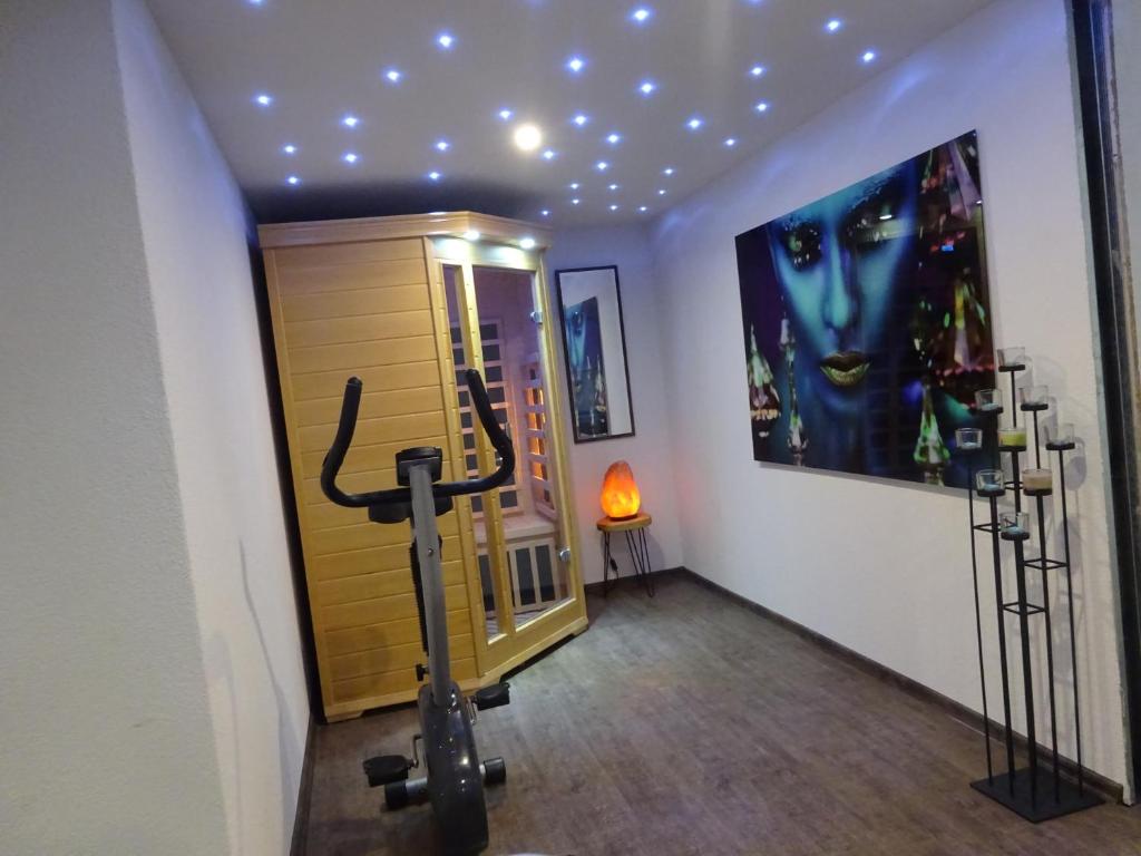 a room with a gym with a large poster on the wall at family friendly apartment 3 adults plus child in Ružomberok