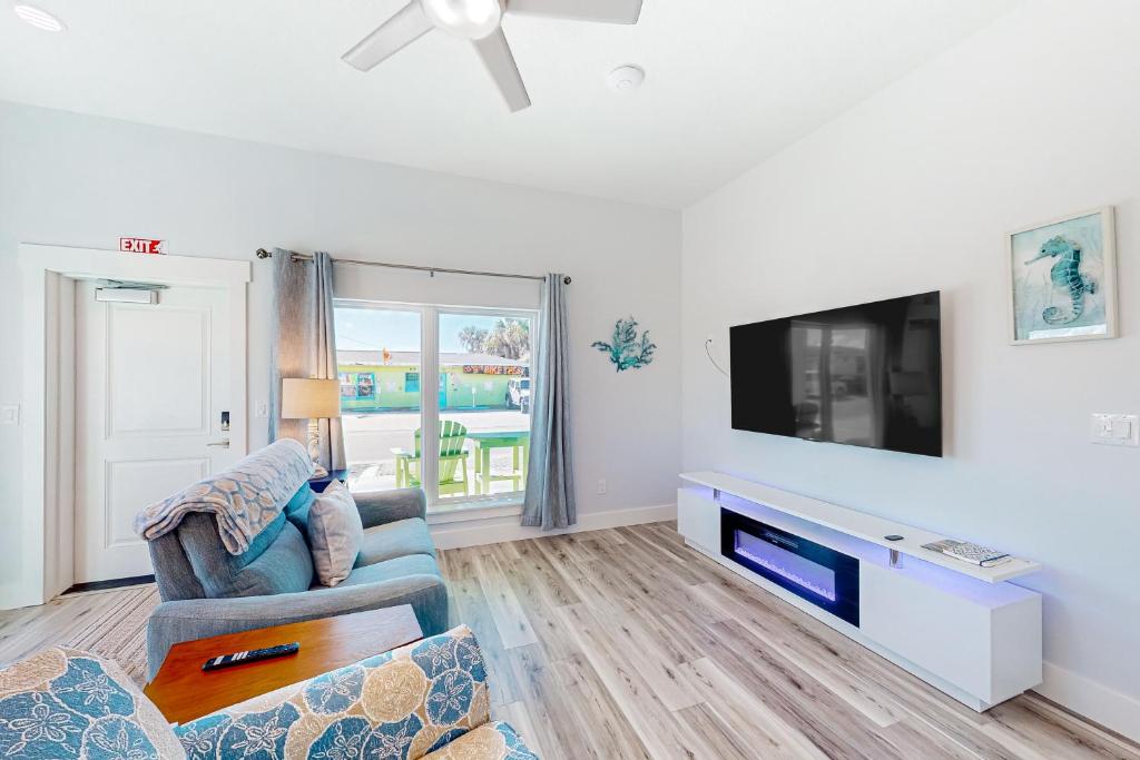 a living room with a tv and a couch at Salty Waves 1 in Flagler Beach