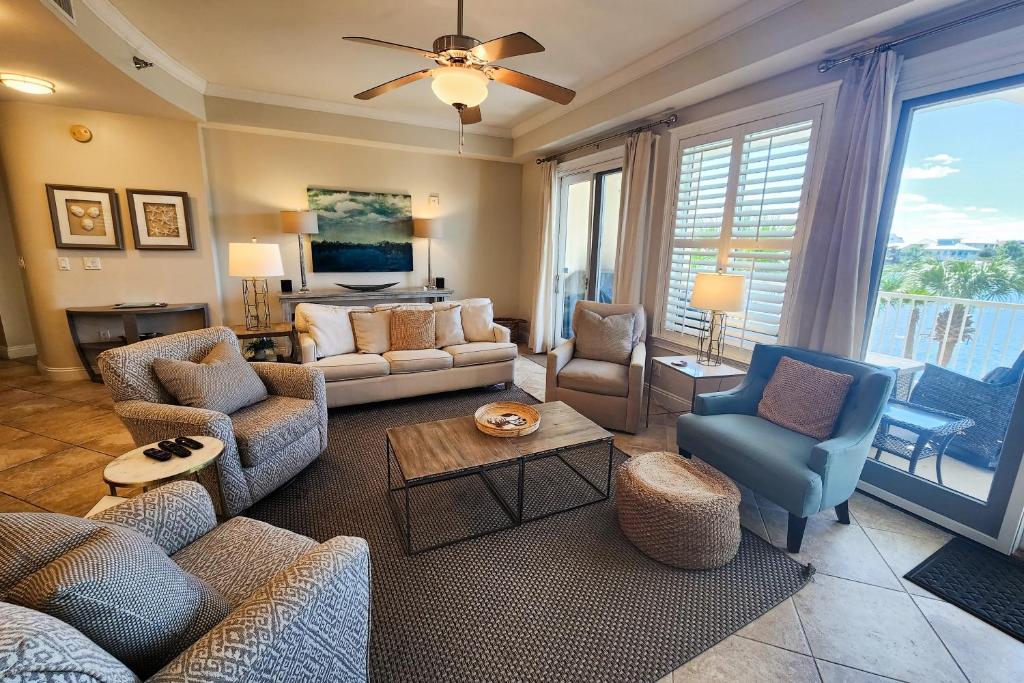 a living room with couches and chairs at Sunset Retreat in Panama City Beach
