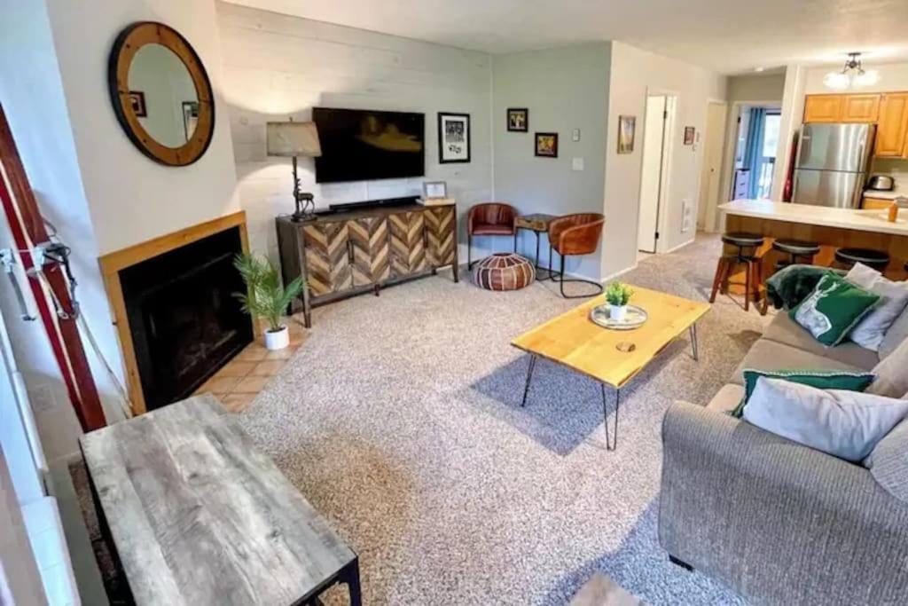 a living room with a couch and a fireplace at Perfect Mt. Location! Skiing, Hiking, Biking, Pool in Eden