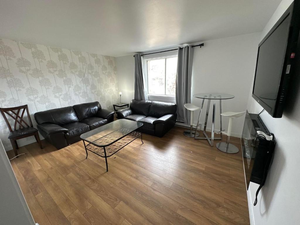 a living room with a couch and a table at Appartement une chambre - 576 in Montreal