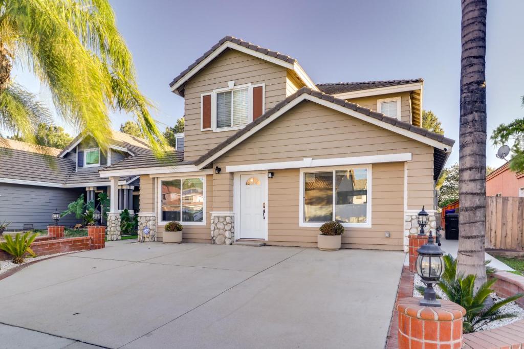 a house with a palm tree at Fast WiFi and Free Parking Cozy Fontana Apartment in Fontana