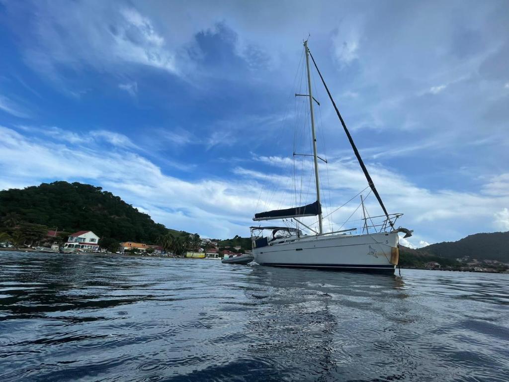 a sailboat sitting in the water on a lake at Le Voilier dans la baie des Saintes in Terre-de-Haut