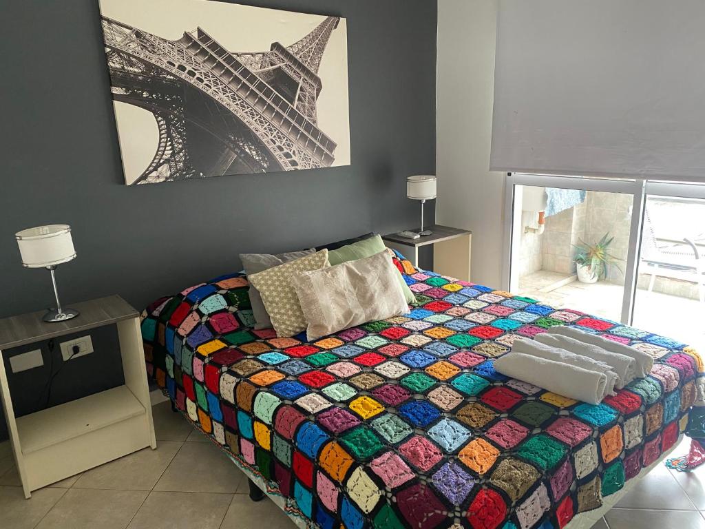 a bedroom with a bed and a picture of the eiffel tower at Departamento 3 centro - Cardiológico con cochera in Corrientes