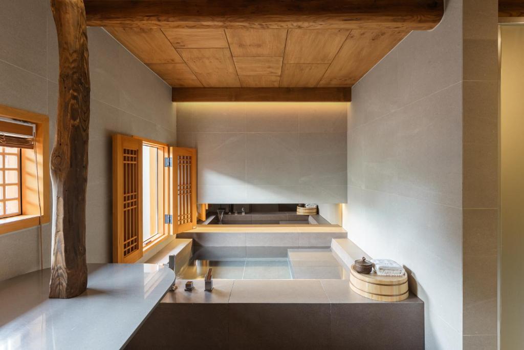 a living room with a wooden ceiling at Luxury hanok with private bathtub - Happyjae in Seoul