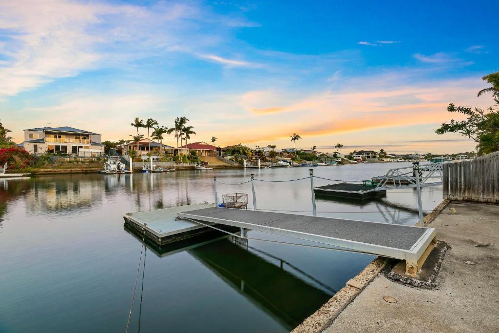 a dock with two boats in a body of water at Happiness On Hoya in Bongaree