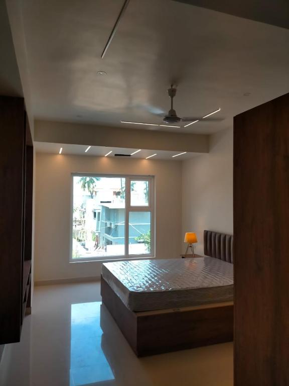Postel nebo postele na pokoji v ubytování DrizzleDrop Inn Chennai