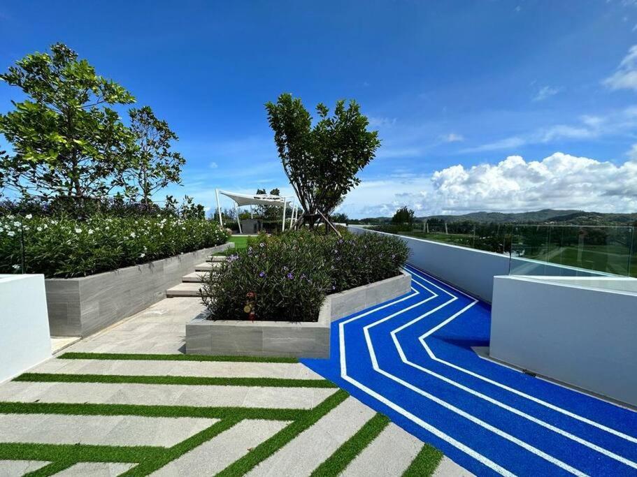 a walkway with blue and white stripes on a house at 普吉岛Laguna海滩豪华天际泳池公寓，奢华体验与休闲之选 in Phuket Town