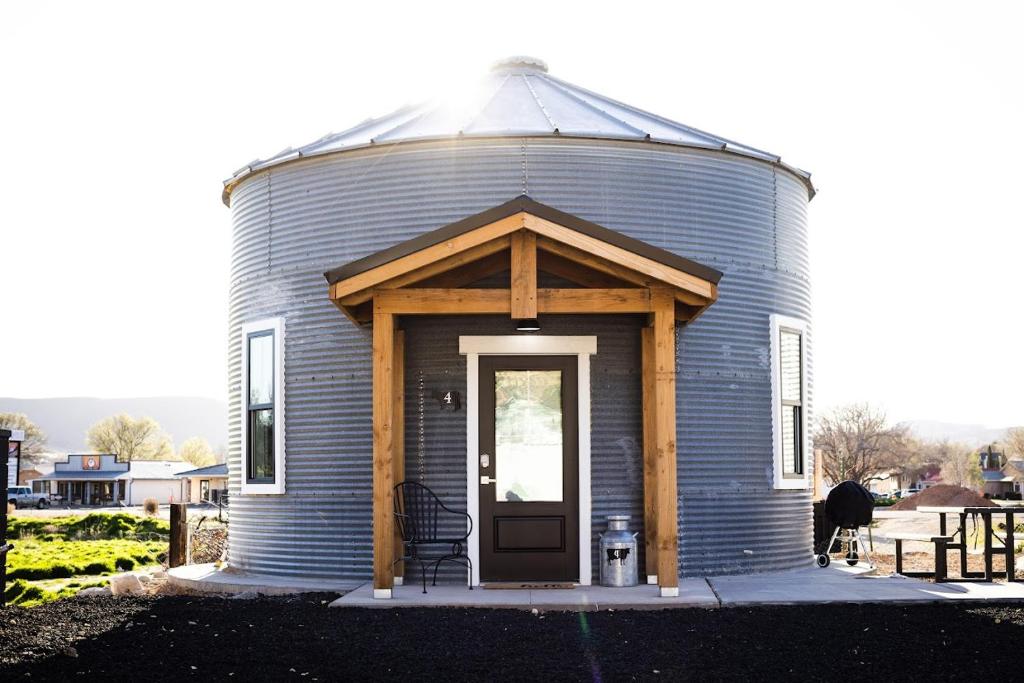 a blue silo with a porch and a door at Silo Suite 4- Near Zion National Park in La Verkin