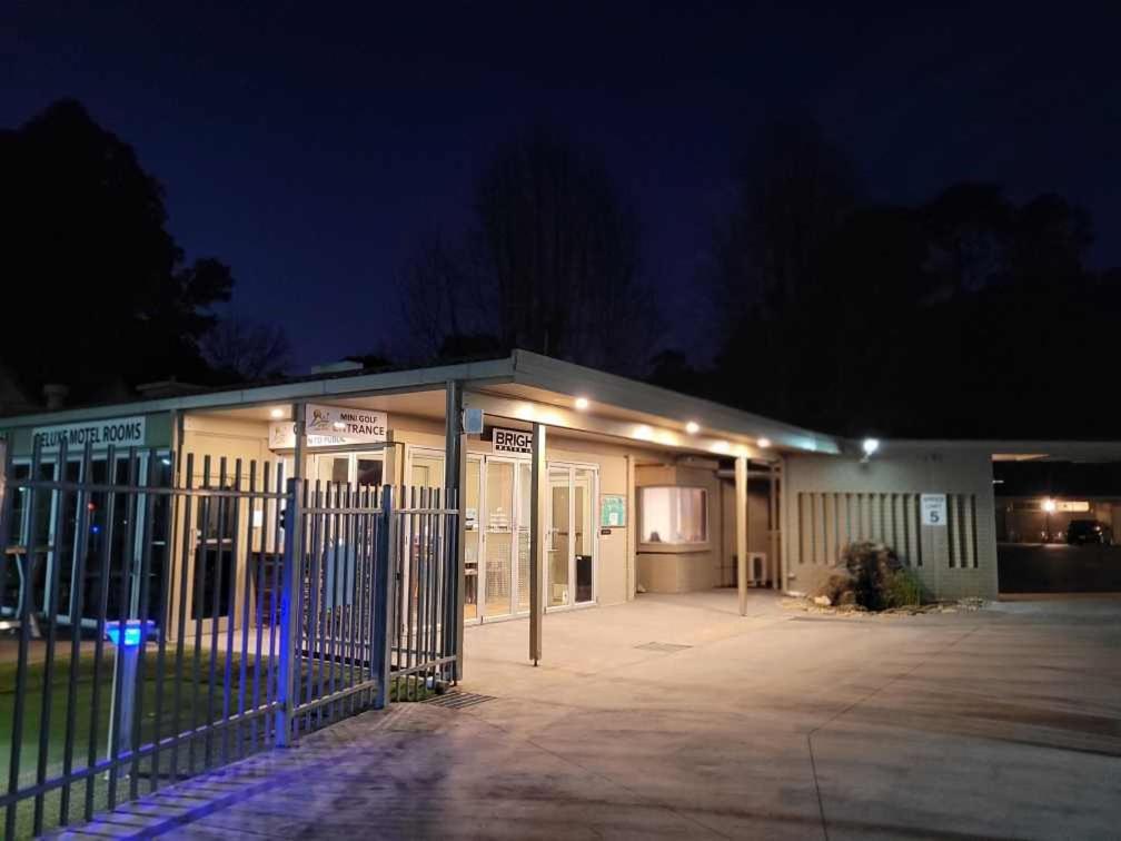 a building with a fence in front of it at night at Bright Motor Inn in Bright