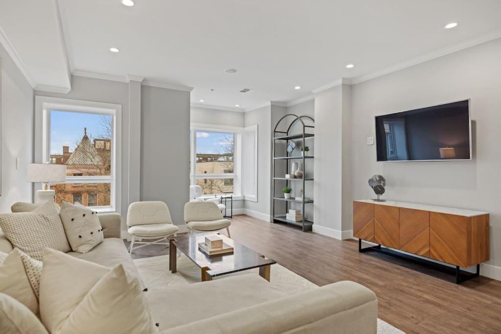 a living room with a couch and a flat screen tv at Luxury DC Penthouse w/ Private Rooftop! (Chapin 4) in Washington