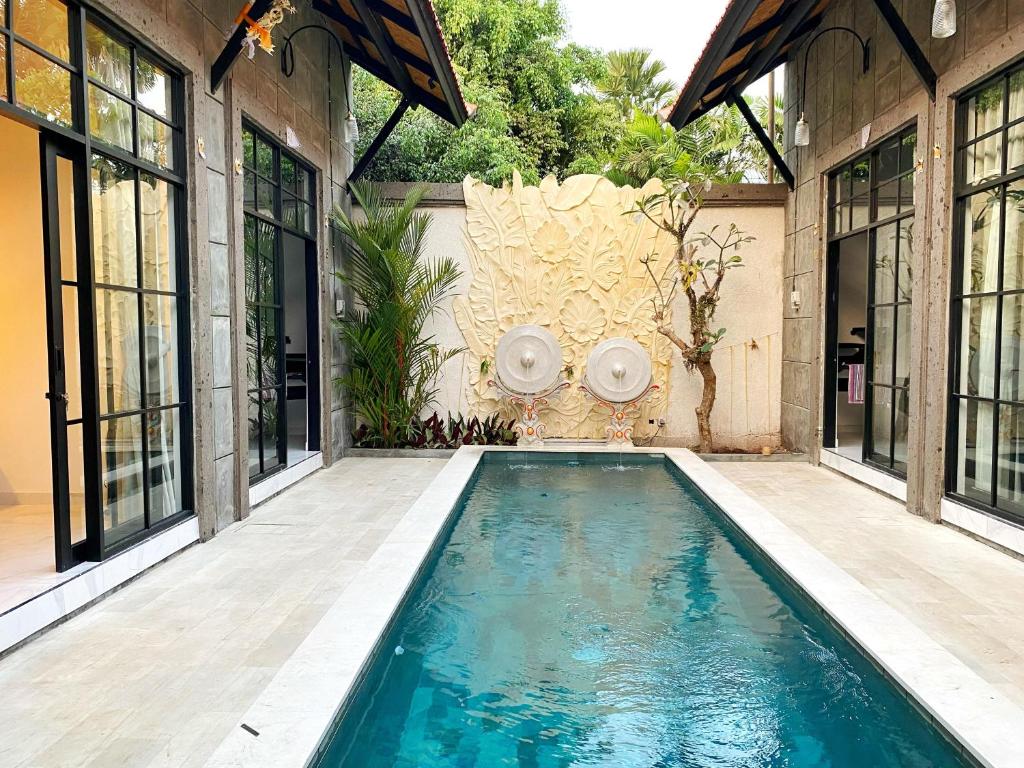 a swimming pool in the middle of a house at ND LOFT 2 by Kasta Hospitality in Canggu