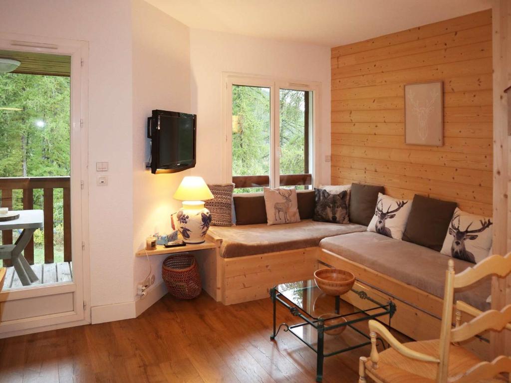 un salon avec un canapé et une télévision dans l'établissement Joli duplex 7 pers aux Orres 1650 avec balcon et cuisine équipée - FR-1-322-537, aux Orres