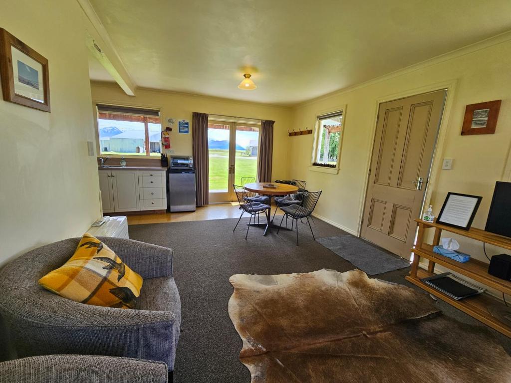 a living room with a couch and a table at The Cabin, Omahau Downs in Twizel