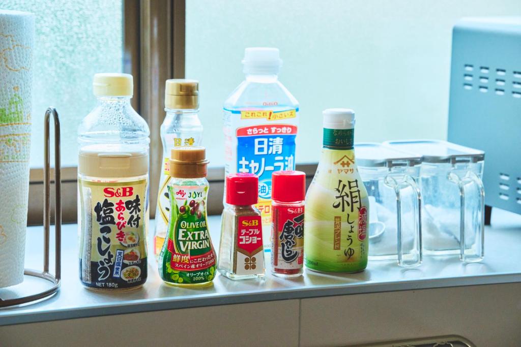 a counter with bottles of sauce and condiments on it at TEMPLESTAY ZENSŌ in Chiyodamachi